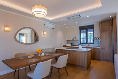 a kitchen and dining room with a table and chairs at Villa Seaside Shore in Budva