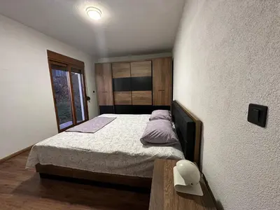 a small bedroom with a bed and a window at A&N Apartments in Ulcinj