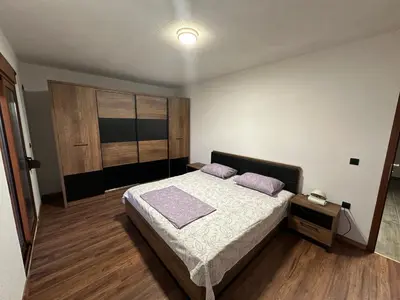 a bedroom with a bed with purple pillows on it at A&N Apartments in Ulcinj