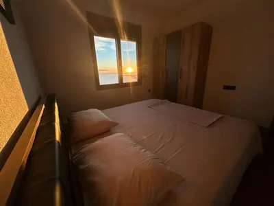 a bedroom with a white bed with a window at A&N Apartments in Ulcinj