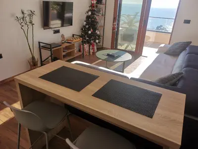 a living room with a table and a christmas tree at A&N Apartments in Ulcinj