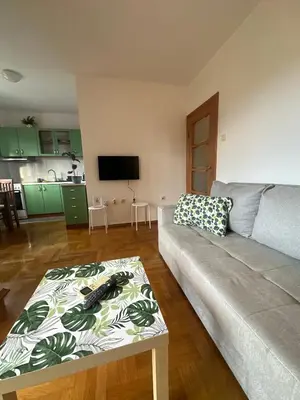 a living room with a couch and a table at Sunny Studio Podgorica in Podgorica