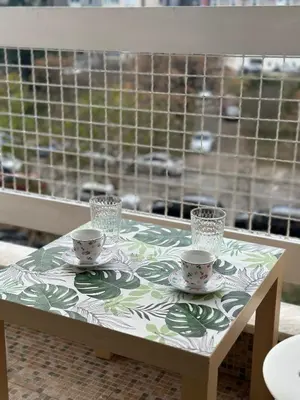 a table with two cups and saucers on it at Sunny Studio Podgorica in Podgorica