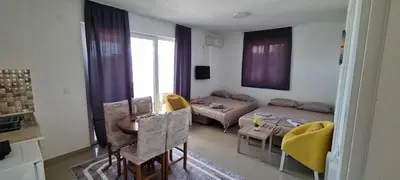 a living room with a couch and a table at Apartments Nahla in Bar
