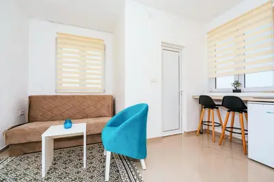 a living room with a couch and a table and chairs at Apartments Nahla in Bar