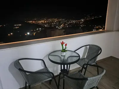 a table and chairs with a view of a city at Apartments Nahla in Bar