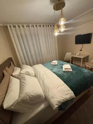 a bedroom with a bed with two towels on it at Bella Studio in Podgorica