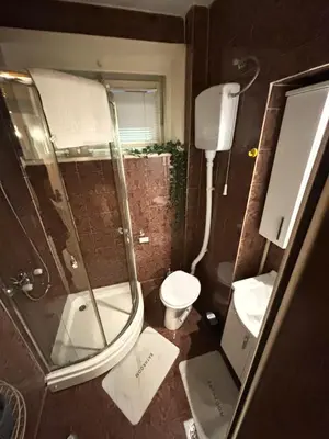 a small bathroom with a shower and a toilet at Bella Studio in Podgorica
