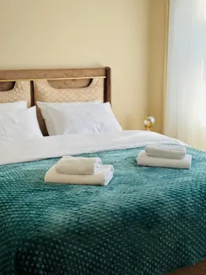 two towels sitting on top of a bed at Bella Studio in Podgorica