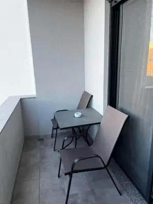 a small table and chairs on a balcony at Amore in Ulcinj