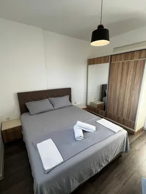 a bedroom with a bed with two towels on it at Amore in Ulcinj