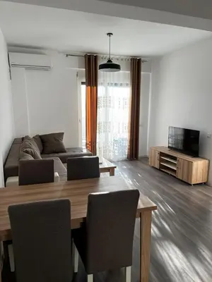 a living room with a table and a couch at Amore in Ulcinj