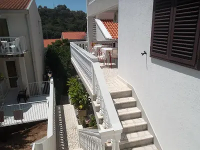 a stairway leading to a balcony of a house at Guest House 4M in Petrovac na Moru