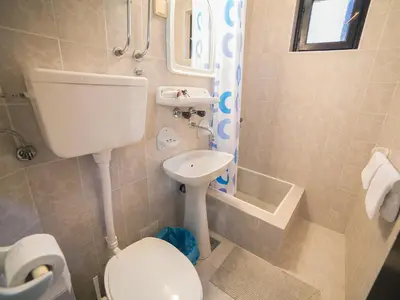 a bathroom with a toilet and a sink at Guest House 4M in Petrovac na Moru