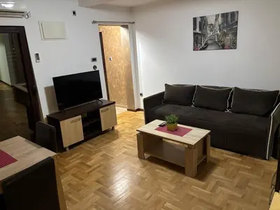 a living room with a couch and a flat screen tv at Apartment Laura in Budva