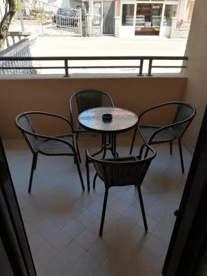 a table and chairs on a balcony with a table at Apartment Laura in Budva