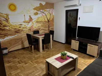 a living room with a table and a flat screen tv at Apartment Laura in Budva