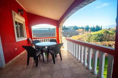 a patio with a table and chairs on a balcony at Milic Apartmant with parking in Bar