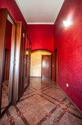 an empty room with red walls and a hallway at Milic Apartmant with parking in Bar