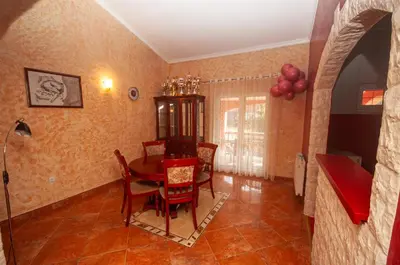 a dining room with a table and chairs at Milic Apartmant with parking in Bar