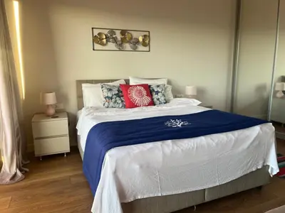 a bedroom with a large bed with a blue blanket at Apartments Zevs Kavac in Kavač