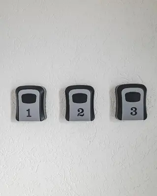 three switches on a wall with numbers on them at Moon apartment 1 in Podgorica