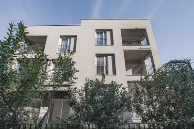 an apartment building with windows and trees at Moon apartment 1 in Podgorica