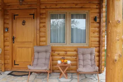two chairs sitting on the porch of a log cabin at Cottage retreat- Skadar Lake in Virpazar
