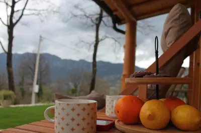 a table with oranges and coffee cups on it at Cottage retreat- Skadar Lake in Virpazar