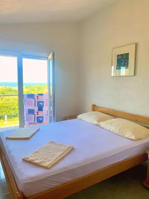 a bedroom with a large bed with a window at Spacious Home with Stunning Mountain and Sea Views , Bar, Dobre Vode Montenegro in Bar