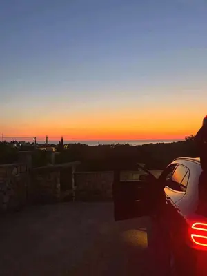 a car parked in front of a sunset at Spacious Home with Stunning Mountain and Sea Views , Bar, Dobre Vode Montenegro in Bar