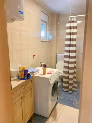 a bathroom with a sink and a washing machine at Spacious Home with Stunning Mountain and Sea Views , Bar, Dobre Vode Montenegro in Bar