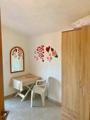 a room with a table and a chair and a mirror at Spacious Home with Stunning Mountain and Sea Views , Bar, Dobre Vode Montenegro in Bar