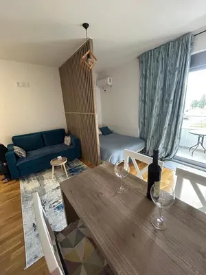 a living room with a table and a couch at G4 Apartment in Ulcinj