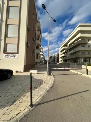 a street light on the side of a street with buildings at G4 Apartment in Ulcinj