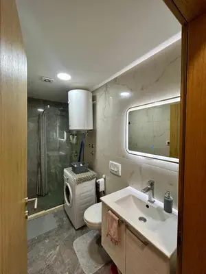 a bathroom with a sink and a toilet and a shower at G4 Apartment in Ulcinj