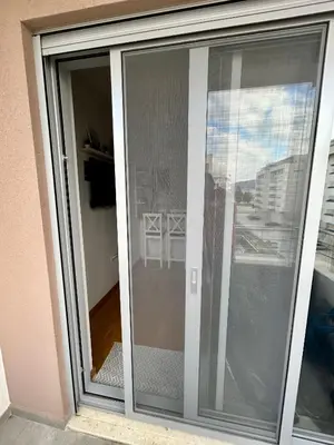 a sliding glass door with a view of a balcony at G4 Apartment in Ulcinj
