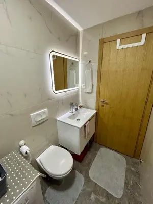 a bathroom with a toilet and a sink and a mirror at G4 Apartment in Ulcinj