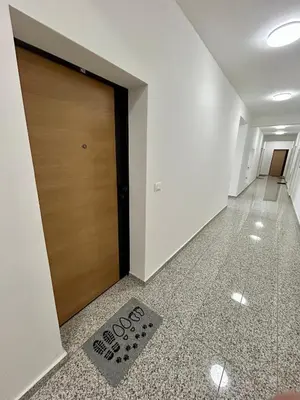 a door in a hallway with a sign on the floor at G4 Apartment in Ulcinj