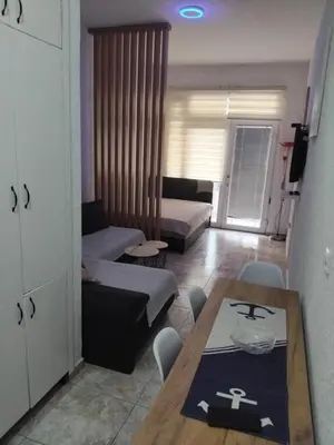 a living room with a couch and a table at AK apartman in Sutomore