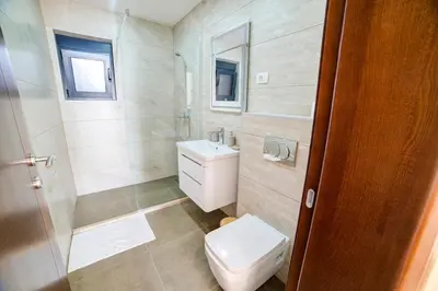 a bathroom with a toilet and a sink at Villa Jelena with private pool - Lapcici in Budva