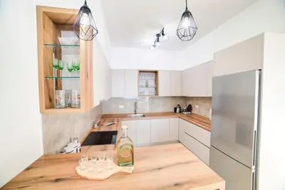 a kitchen with a counter with a bottle of wine on it at Villa Jelena with private pool - Lapcici in Budva