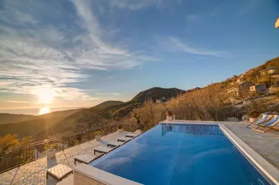 a swimming pool with a view of the mountains at Villa Jelena with private pool - Lapcici in Budva