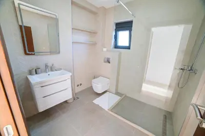 a bathroom with a sink and a toilet and a shower at Villa Jelena with private pool - Lapcici in Budva