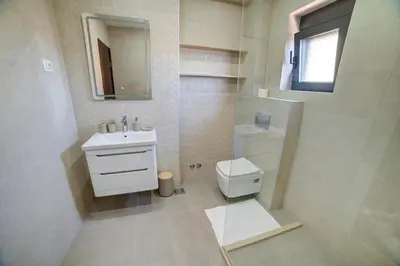 a bathroom with a toilet and a sink and a mirror at Villa Jelena with private pool - Lapcici in Budva