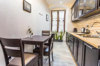 a kitchen with a table and chairs and a sink at Pearl Apartments in Kotor