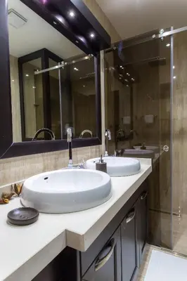 a bathroom with two sinks and a large mirror at Pearl Apartments in Kotor