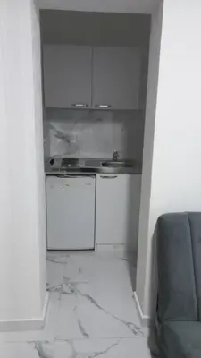a white kitchen with a stove and a sink at Apartments Armini in Ulcinj
