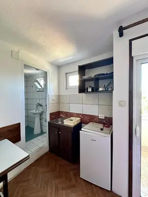 a small kitchen with a sink and a shower at Heaven Apartments in Ulcinj