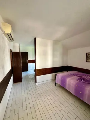 a bedroom with a purple bed in a room at Heaven Apartments in Ulcinj